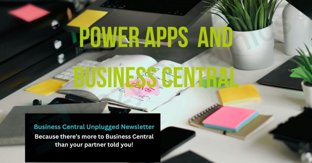 Desk with open journal, a printer, and post-it notes with overlay text 'Power Apps and Business Central'